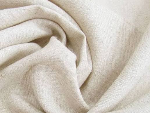 Undyed linen cloth folded into soft creases
